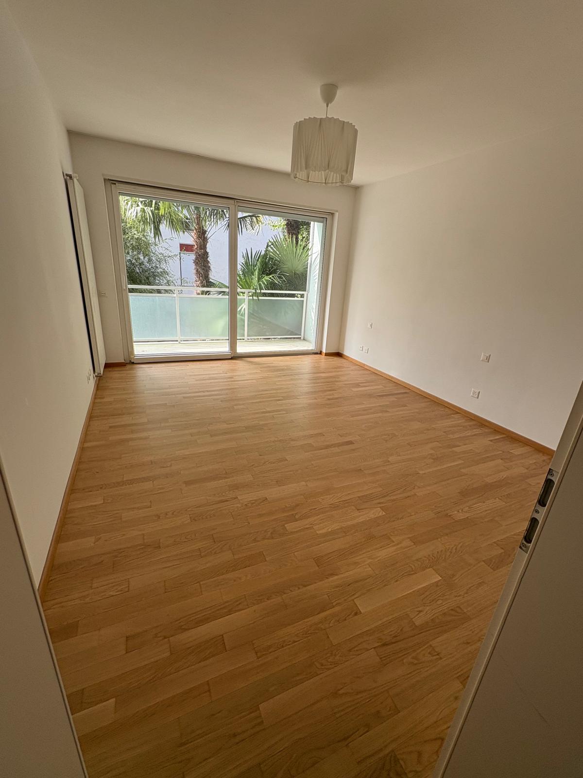 Main bedroom with balcony access and view of palm trees